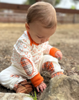 Mini Britches Long Sleeve Onesie in Orange Horse Shoe