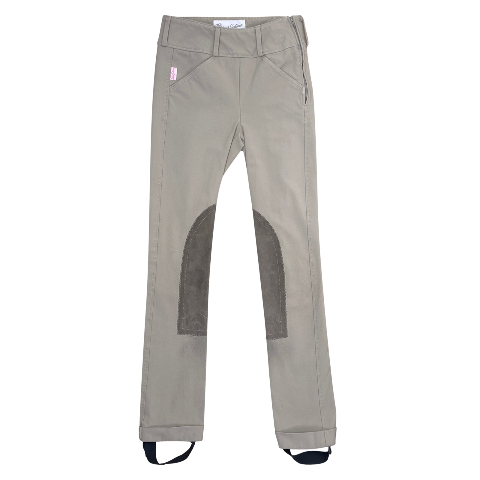 Tan riding pants with knee patches on a white background