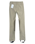 Tan pants with a tag on a white background