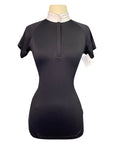 Black short-sleeve top on a mannequin with a white background