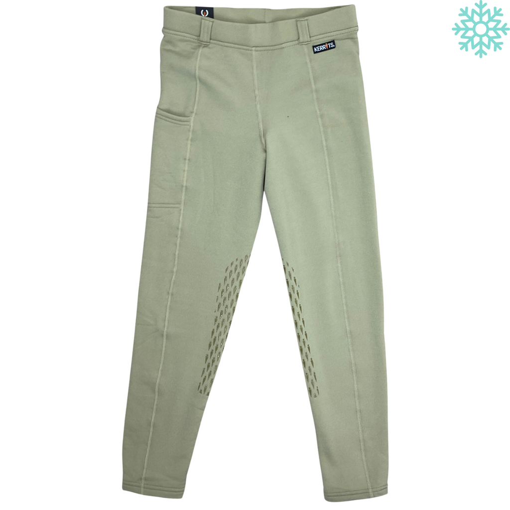 Green riding pants with a brand label on a white background