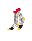 Pair of socks with a grid pattern, red top, black and yellow toes on a white background