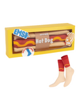 Hot dog-shaped socks in a yellow box.