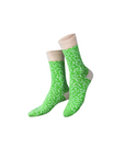 Pair of green patterned socks on a white background