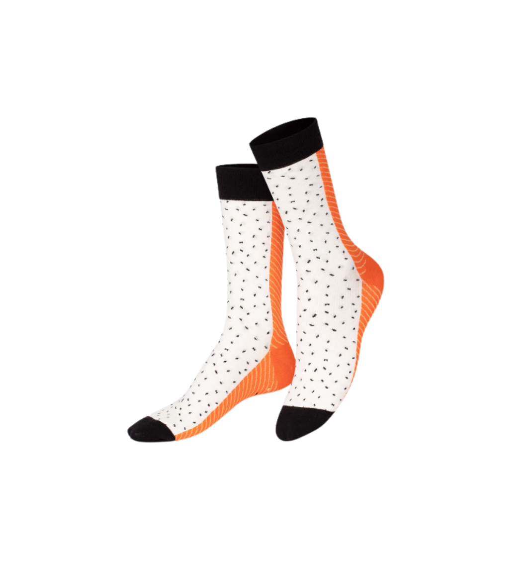 Pair of socks with white pattern and orange accents on a white background