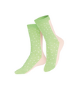 Pair of green polka dot socks on a white background