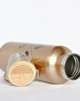Gold insulated bottle with wooden cap on a white background